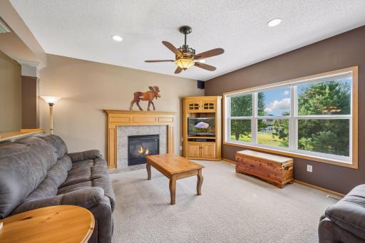 Relax and unwind in the spacious family room, featuring a cozy gas fireplace and large windows that frame peaceful backyard views. A welcoming space for movie nights, quiet evenings, and gathering with family and friends.