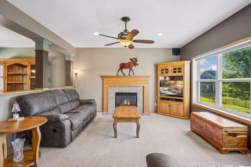 Relax and unwind in the spacious family room, featuring a cozy gas fireplace and large windows that frame peaceful backyard views. A welcoming space for movie nights, quiet evenings, and gathering with family and friends.