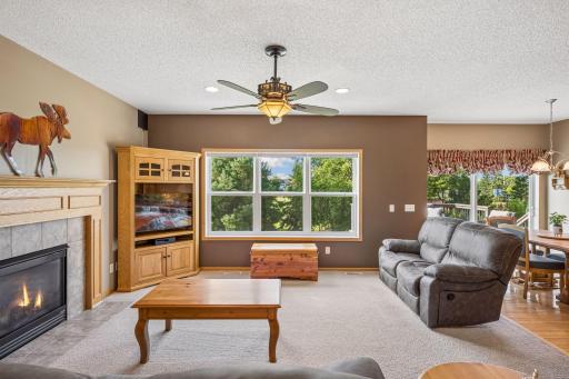 Relax and unwind in the spacious family room, featuring a cozy gas fireplace and large windows that frame peaceful backyard views. A welcoming space for movie nights, quiet evenings, and gathering with family and friends.