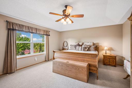 Primary bedroom offers generous space to relax from the day, including a sitting area and private primary bathroom suite access