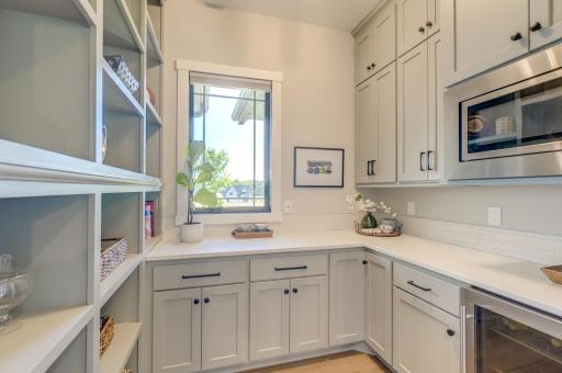 Spacious butlerâs pantry features floor-to-ceiling cabinetry for exceptional storage!