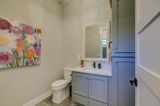 Convenient half bath offers a stylish and welcoming space for guests and everyday living!