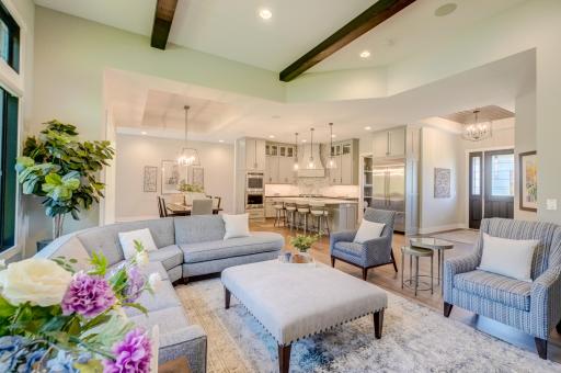 Open great room showcases architectural details, varying ceiling heights, and expansive windows!