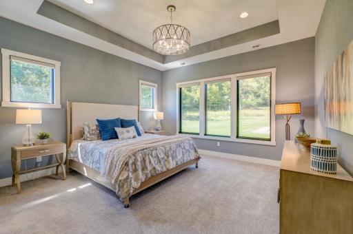 Unwind in the private primary suite offering a relaxing retreat with a spacious walk-in closet and luxurious bath!