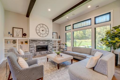 Walls of windows fill the living spaces with natural light while framing beautiful views of the private acreage!