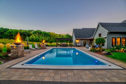 Gas-fired pillars surrounding the pool create a dramatic glow in the evening!
