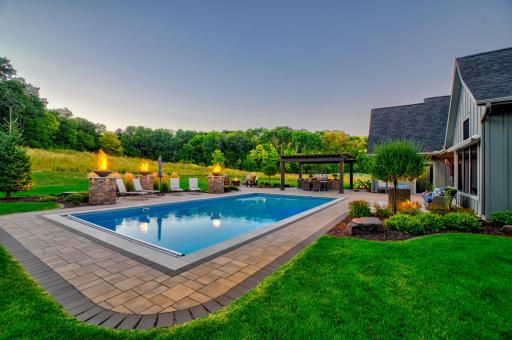 Designed to impress day or night, the pool area offers an incredible setting for evening entertaining while enjoying the quiet beauty of over 5 private acres!