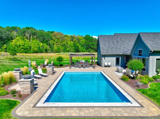 Relax in your heated pool with automatic cover, surrounded by beautiful landscaping and peaceful wooded views!