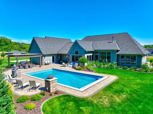 An exceptional outdoor entertaining space with a pool, fire pit, built-in grill, and pergola!