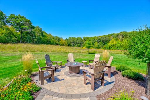 Private woods in the distance create a picturesque backdrop for the backyard!