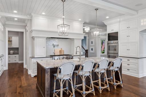 A 2015 custom build and designed by Denali Custom Homes who only builds one-of-a-kind estates. This kitchen is chefs kiss and has double ovens and oversized walk in pantry. Just off the kitchen is your fireside room.