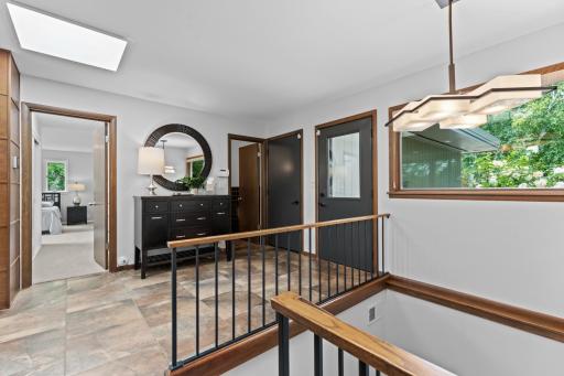 Foyer leading to the garage, main level half bathroom and primary suite.