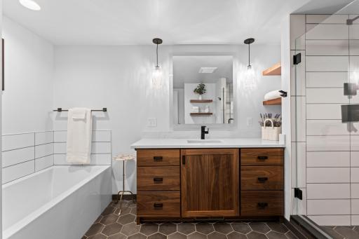 Featuring a tiled shower and spacious soaking tub.
