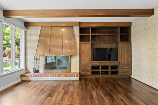 Lower level family room is anchored by the distinctive fireplace.