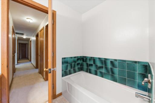 Main level bathroom with separate tub and shower.