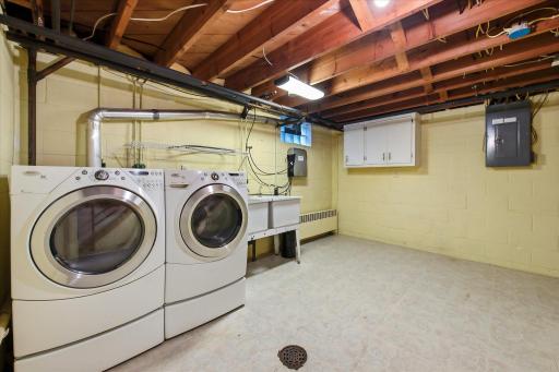 Newer washer and dryer with pedestals in the laundry room.