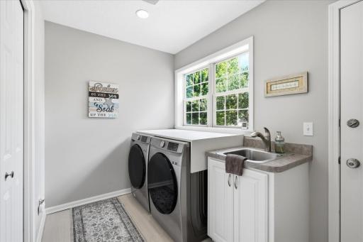 Main level Laundry Room w/tile floors, newer Samsung washer/dryer, wet sink and windows