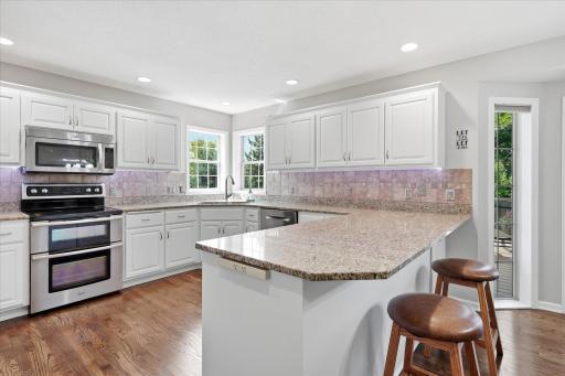 Remodeled Kitchen includes granite counter tops, undermount ss sink, raised panel white cabs, tile backsplash, lazy susan