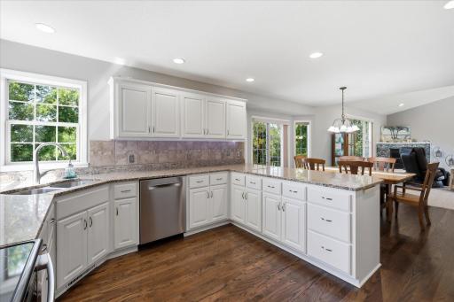 Corner windows, LED recessed can lighting, under/over cabinet lighting strips + wood floor