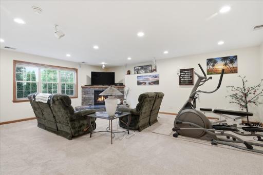 Walkout Family and Game Rooms features gas corner fireplace w/stone surround