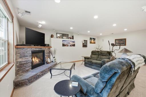 Walkout Family and Game Rooms features gas corner fireplace w/stone surround