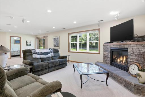 Walkout Family and Game Rooms features gas corner fireplace w/stone surround and LED Recessed lights on dimmers, built-in Bose/JBL speakers