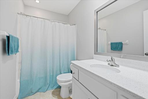 Upper level updated Full Bathroom: quartz ctr top white vanity + updated lighting including tub