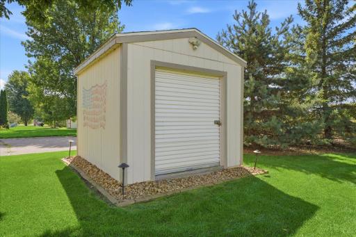 Storage shed w/solar lighting + pull up door. Store your lawn equipment and toys all year around. Irritation system keeps the lawn, trees and plantings green