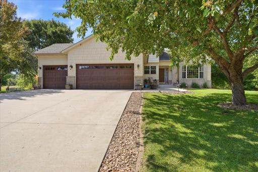 Spacious 3 car insulated garage with expoy floor and storage shelving. Concrete driveway and front sidewalk