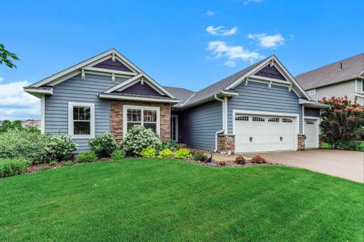 Thoughtfully designed landscaping frames the home with polished curb appeal and a welcoming, well-kept presence.