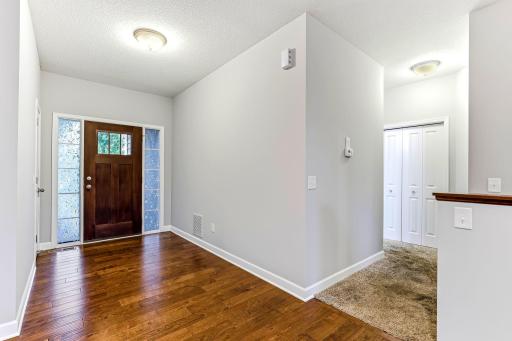 The open entry showcases beautiful flooring that stretches throughout the space, adding warmth, style, and a polished first impression.