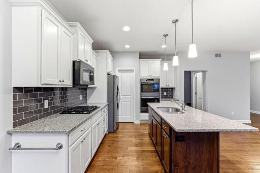 Expansive quartz countertops provide generous workspace with a sleek, high-end finish.