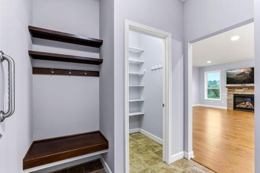 This organized drop zone keeps shoes, bags, and daily essentials neatly contained, making the main-level laundry both functional and welcoming.