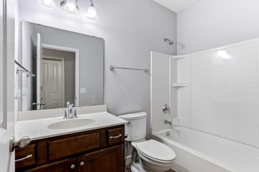 A bright, modern full bath on the main level featuring a clean layout, quality finishes, and convenient access for guests and everyday use.