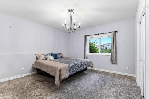A private and comfortable fourth bedroom on the lower level, offering generous space, soft natural light, and a quiet setting ideal for guests, teens, or a dedicated work or hobby room.