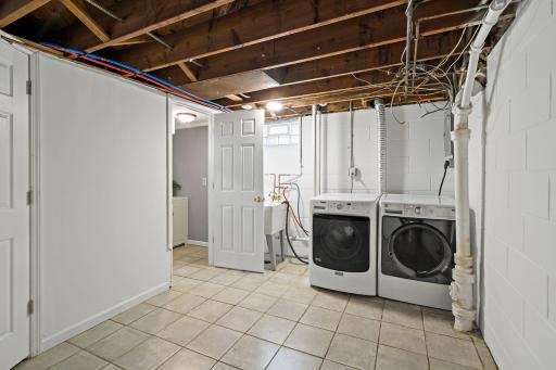 Unit 3810 - There is a spacious laundry room with ceramic flooring and laundry tub. The mechanical room is adjacent to laundry room. New hot water heater 2021.