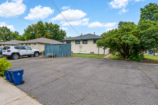 There is a large asphalt area for parking in back with sidewalks to each unit. There is also a storage shed.