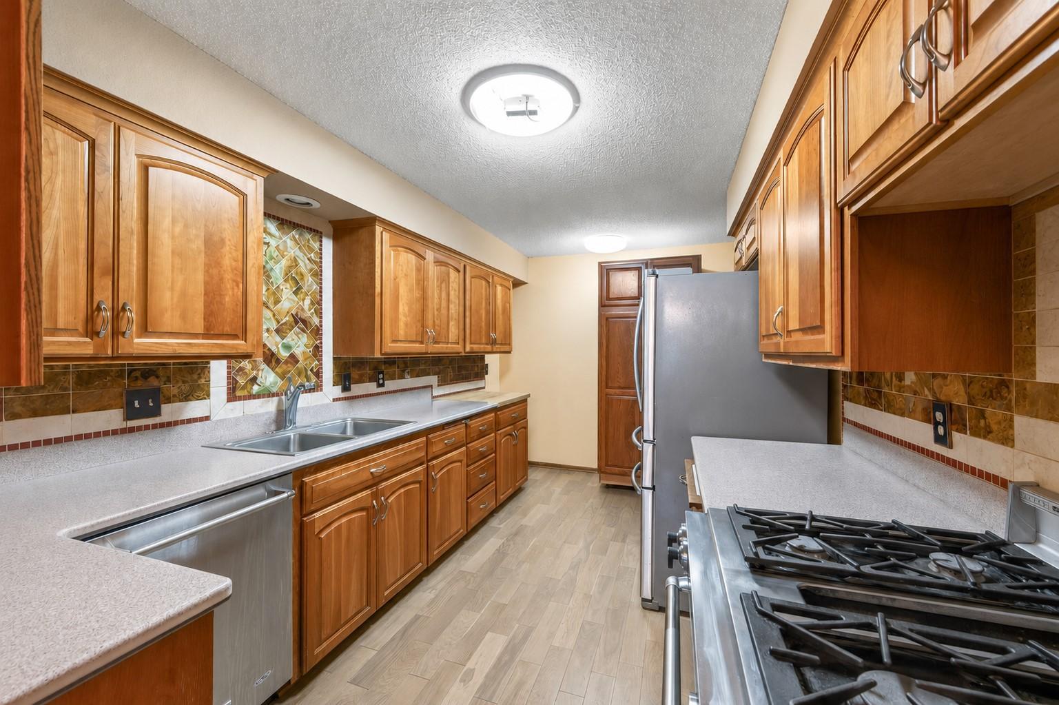 Kitchen with SS appliances.