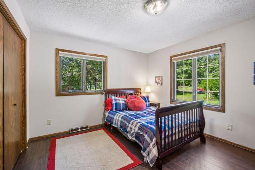 The second bedroom on the main floor is spacious and bright with windows on two walls and hard surface flooring for easy clean up.