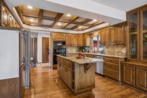 There is plentiful storage and counter space as well as a full wall of custom built-in cabinetry that extends into the dining area. The garage entrance is conveniently located near the kitchen, off the mud room, for easy unloading of groceries.