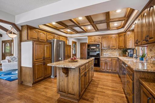 The warm and welcoming kitchen has a newer stainless refrigerator and dishwasher as well as an induction cooktop and wall oven/microwave combo. The kitchen windows overlooks the fully fenced side yard.