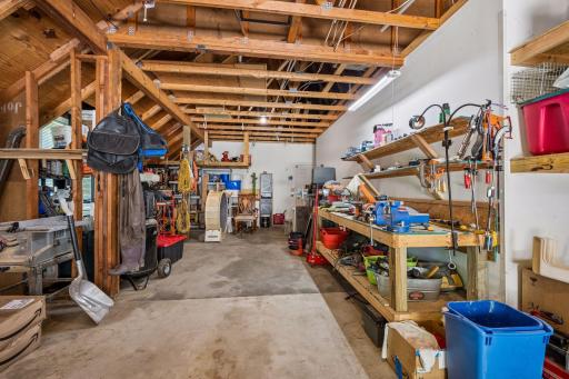 The third stall is tandem and has a handy work bench and lofted storage.