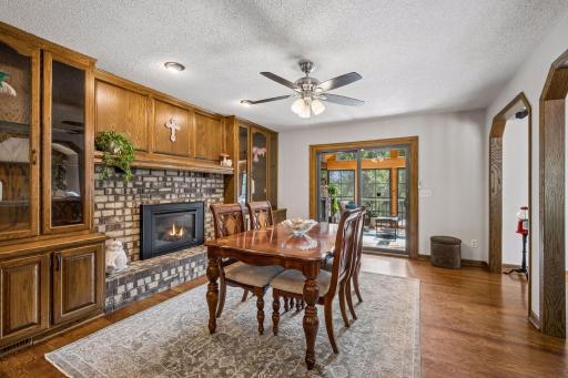 Built in hutches on either side of the cozy gas fireplace offer plentiful storage and glassed upper cabinets let you display your favorite pieces.