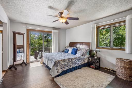 The owners suite has solid surface flooring, a breezy ceiling fan, double closets as well as built-in storage in the dressing area. Sliding doors offer direct access to the rear deck overlooking the pool and river views.