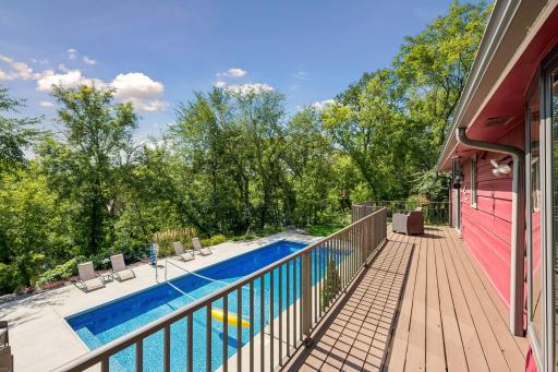 The deck off the Sunroom runs the entire rear length of the home with commanding views of the pool area and beyond to the private nature and river views.