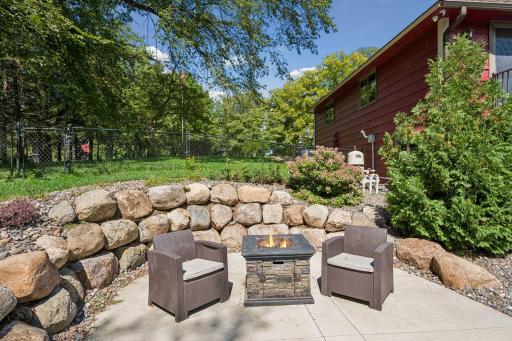 The side patio has a charming boulder retaining wall and makes an ideal fire pit area.