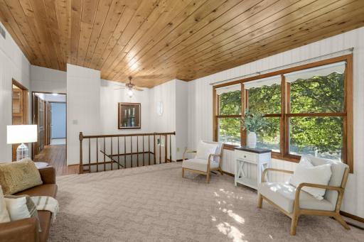 Vaulted Living Room with a warm wood ceiling and large front windows.