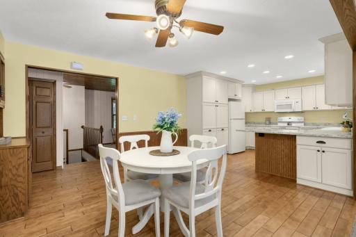 Huge updated Kitchen with white cabinetry, hardwood floors and a large peninsula.