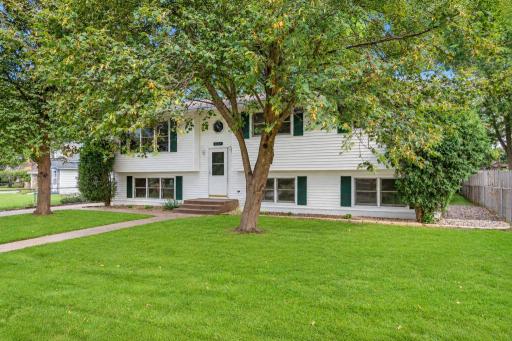 Mature trees and a welcoming front entrance.