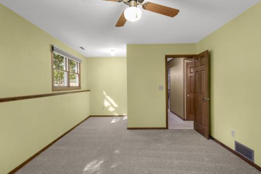 Another view of this bedroom with space for a desk or sitting area.